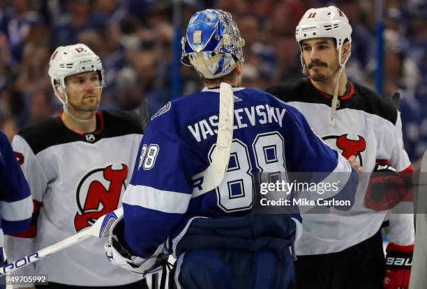 Andrei Vasilevskiy of the Tampa Bay Lightning shakes hands with Brian Boyle of the New Jersey Devils as Ben Lovejoy looks on after Game Five of the...