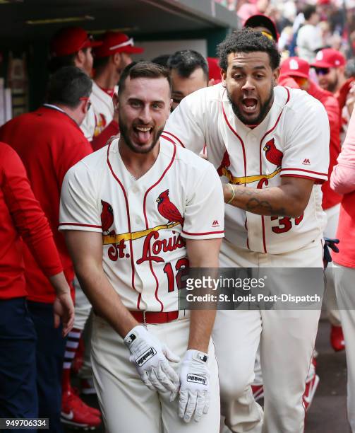 The St. Louis Cardinals' Paul DeJong, left, celebrates with teammates, including Jose Martinez, right, in the dugout after he hit a two-run home run...