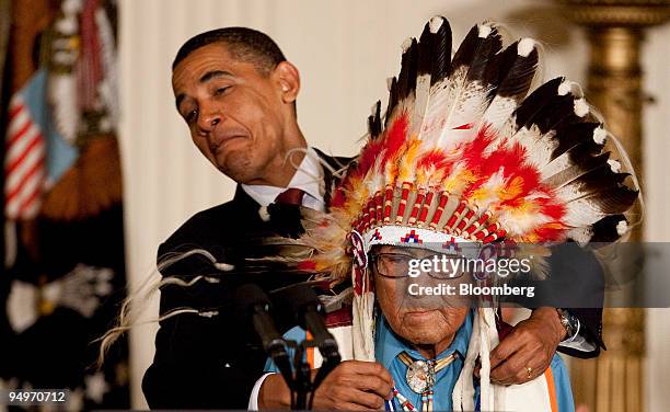 President Barack Obama attempts to give Joseph Medicine Crow, the last living Plains Indian war chief, the 2009 Presidential Medal of Freedom during...
