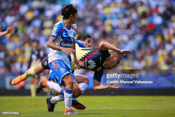 Omar Fernandez and Alonso Zamora of Puebla fight for the ball with Paul Aguilar of America during the 16th round match between Puebla and America as...