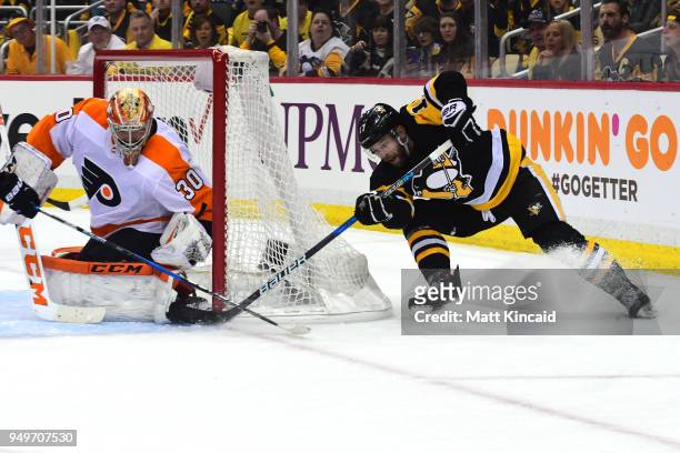 Bryan Rust of the Pittsburgh Penguins scares a goal against Miichal Neuvirth of the Philadelphia Flyers in Game Five of the Eastern Conference First...