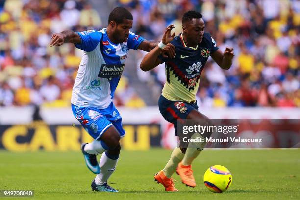 Brayan Angulo of Puebla struggles for the ball against Alex Ibarra Mina of America during the 16th round match between Puebla and America as part of...