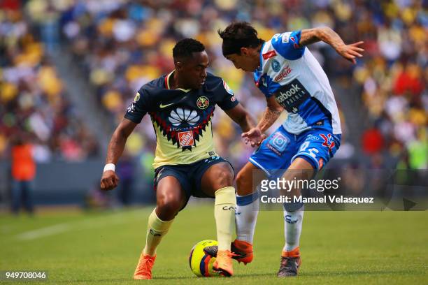 Omar Fernandez of Puebla struggles for the ball with Alex Ibarra Mina of America during the 16th round match between Puebla and America as part of...