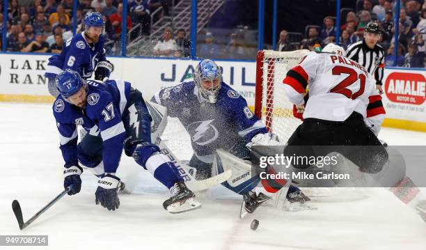 Andrei Vasilevskiy of the Tampa Bay Lightning makes a save against Kyle Palmieri of the New Jersey Devils as Alex Killorn defends in the third period...