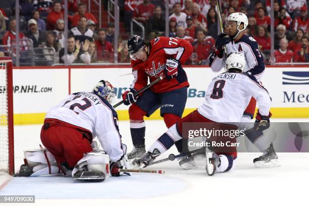 Oshie of the Washington Capitals and Zach Werenski and goalie Sergei Bobrovsky of the Columbus Blue Jackets go after the puck in overtime during Game...