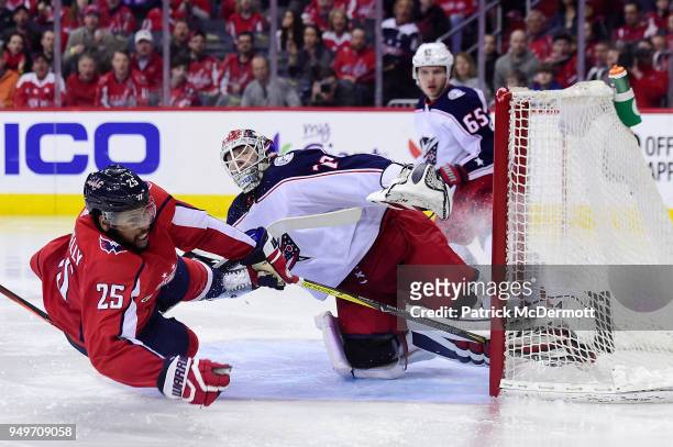 Devante Smith-Pelly of the Washington Capitals and Sergei Bobrovsky of the Columbus Blue Jackets collide in the third period in Game Five of the...