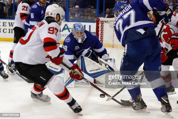 Andrei Vasilevskiy of the Tampa Bay Lightning looks on as Ryan McDonagh clears the puck from Marcus Johansson of the New Jersey Devils in the third...