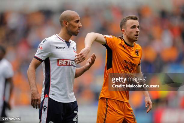 Karl Henry of Bolton Wanderers competes wit Diogo Jota of Wolverhampton Wanderers during the Sky Bet Championship match between Bolton Wanderers and...