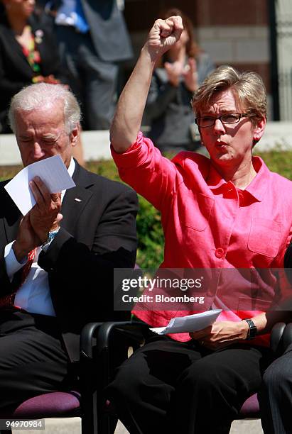 Jennifer Granholm, governor of Michigan, cheers with U.S. Vice President Joseph Biden before they speak at a news conference in Detroit, Michigan,...