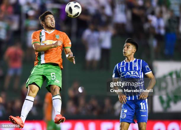 Eric Remedi of Banfield heads the ball against Guillermo Fernández of Godoy Cruz during a match between Banfield and Godoy Cruz as part of Argentina...