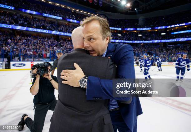 Head Coach Jon Cooper of the Tampa Bay Lightning shakes hands with Head Coach John Hynes of the New Jersey Devils after Game Five of the Eastern...