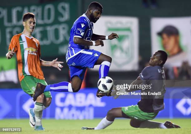 Santiago Garcia of Godoy Cruz jumps over Mauricio Arboleda goalkeeper of Banfield and misses a chance to score during a match between Banfield and...