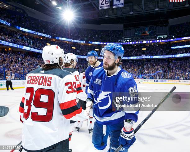 Nikita Kucherov of the Tampa Bay Lightning and Brian Gibbons of the New Jersey Devils shake hands after Game Five of the Eastern Conference First...