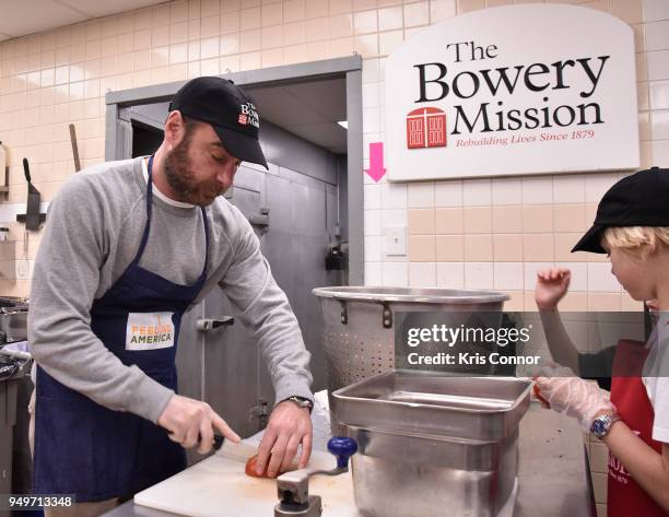 Actor Liev Schreiber volunteers with Feeding America at The Bowery Mission on April 21, 2018 in New York City.