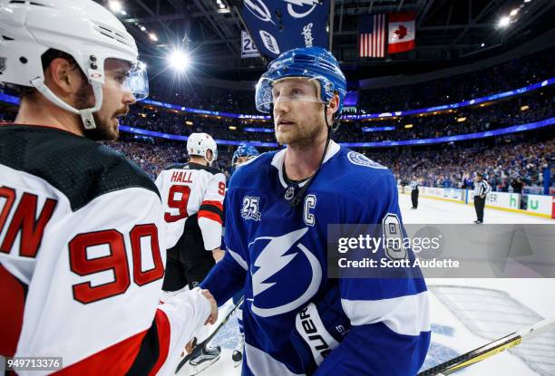 Steven Stamkos of the Tampa Bay Lightning and Marcus Johansson of the New Jersey Devils shake hands after Game Five of the Eastern Conference First...