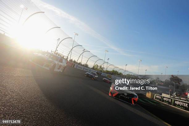 Martin Truex Jr., driver of the Bass Pro Shops/5-hour ENERGY Toyota, leads the field during a pace lap prior to the start of the Monster Energy...