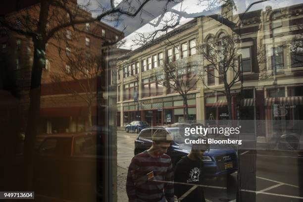 Pedestrians walk on Market Street in the historic district of Corning, New York, U.S., on Monday, March 27, 2017. The Corning Inc., a manufacture of...