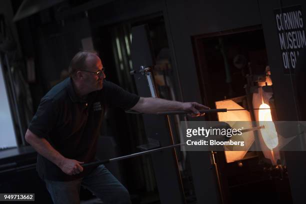 An employee conducts a glass blowing demonstration at the Corning Museum of Glass in Corning, New York, U.S., on Tuesday, March 28, 2017. Corning, a...