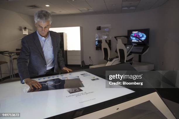 Bill Cleary, manager of marketing and development at Corning Inc., uses a touch screen table made from Gorilla Glass at the company's Sullivan Park...