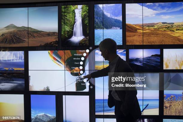 Bill Cleary, manager of marketing and development at Corning Inc., uses a touch screen wall made from Gorilla Glass at the company's Sullivan Park...