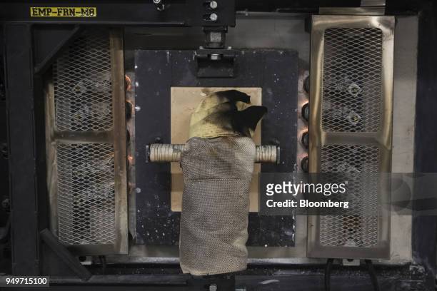 Glove hangs on the door of a glass furnace at the Corning Inc. Sullivan Park Science & Technology Center in Corning, New York, U.S., on Tuesday,...