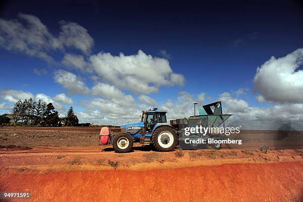 Sugar cane farmer Jay Hubert plants a new crop using a GPS-guided tractor, in Bundaberg, Queensland, Australia, on Friday, Aug. 14, 2009. The 86...