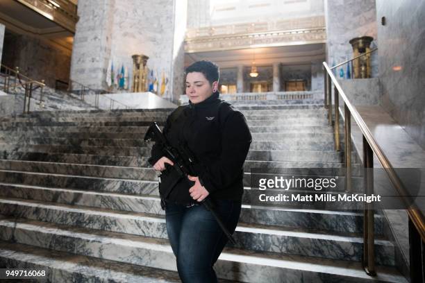 Mariah Foster of Spanaway, Washington carries an assault rifle inside the Washington State Capitol building during a "March For Our Rights" pro-gun...