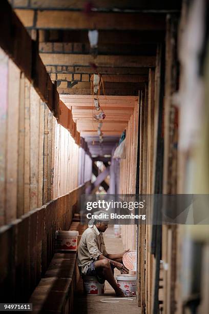 Man paints a walkway in preparation of the Ganesh festival, in Mumbai, India, on Sunday, Aug. 16, 2009. India's economy may expand this year at a...