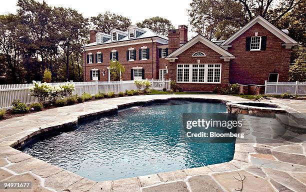 Stone patio surrounds the pool outside a spec home at 38 French Road in Greenwich, Connecticut, U.S., on Monday, Aug. 17, 2009. Greenwich homeowners...