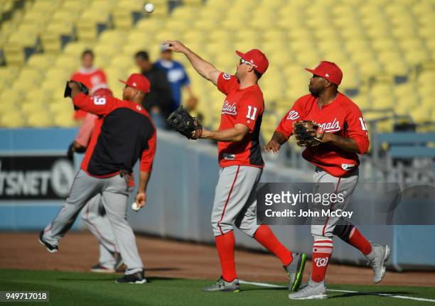 Moises Sierra of the Washington Nationals Ryan Zimmerman and Howie Kendrick warm up before playing the Los Angeles Dodgers at Dodger Stadium on April...