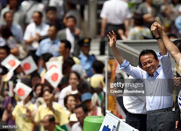 Taro Aso, Japan's prime minister and president of the Liberal Democratic Party , waves during a campaign rally for the general election in Tokyo,...