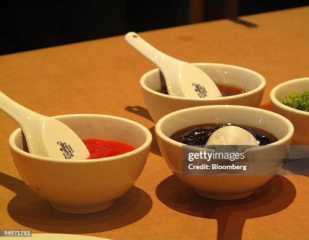 Jalapeno garlic sauce, bibim sauce, hoisin sauce and ginger scallion sauce are shown at Momofuku Noodle Bar in New York, U.S., on July 9, 2009....