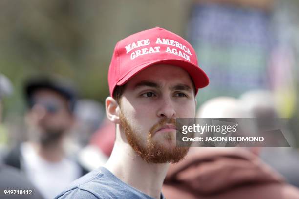 Gun advocate wearing a "Make America Great Again" hat is pictured in front of the Washington state capitol during the "March for Our Rights" pro-gun...
