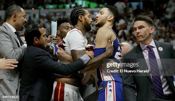 From left, Miami Heat assistant coach Juwan Howard, head coach Erik Spoelstra and referee Jason Phillips intervene to stop an argument between Heat...