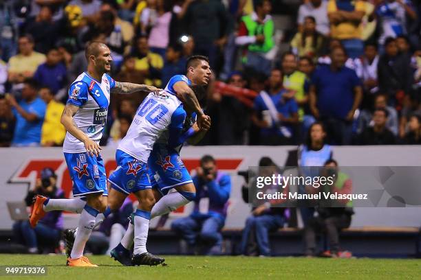 Pablo Gonzalez of Puebla celebrates with teammates after scoring the third goal of his team during the 16th round match between Puebla and America as...