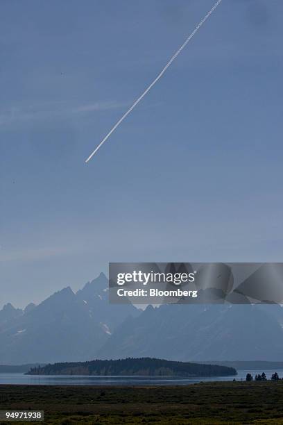 Airplane flies over the Teton Range as seen from the Jackson Lake Lodge in Moran, Wyoming, U.S., on Thursday, Aug. 20, 2009. Thomas Hoenig, president...