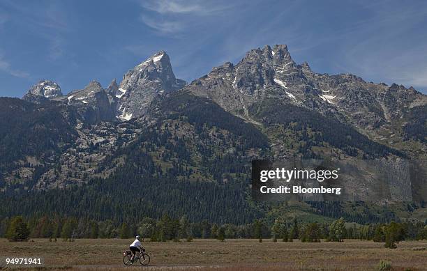 Woman rides a bike on a trail in Grand Teton National Park outside Jackson, Wyoming, U.S., on Thursday, Aug. 20, 2009. Thomas Hoenig, president of...