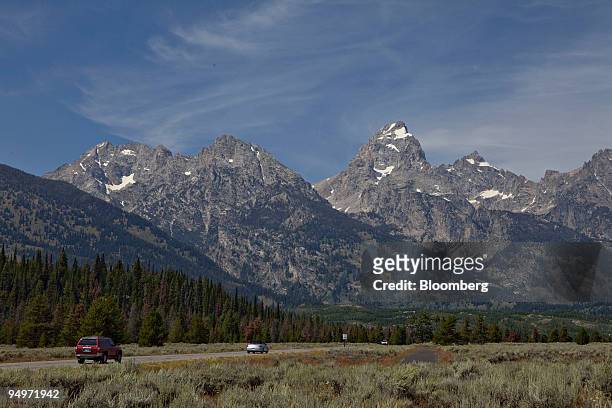 Vehicles drive on a road in Grand Teton National Park outside Jackson, Wyoming, U.S., on Thursday, Aug. 20, 2009. Thomas Hoenig, president of the...