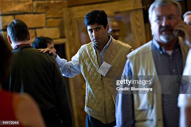 Kevin Warsh, governor of the U.S. Federal Reserve, pats Charles Evans, president of the U.S. Federal Reserve Bank of Chicago, left, on the shoulder...