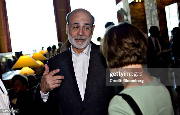 Ben S. Bernanke, chairman of the U.S. Federal Reserve, talks to an attendee during the Jackson Hole Economic Symposium at the Jackson Lake Lodge in...