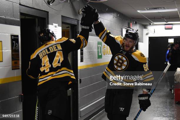 Nick Holden and Kevan Miller of the Boston Bruins high five before warm ups against the Toronto Maple Leafs in Game Five of the Eastern Conference...