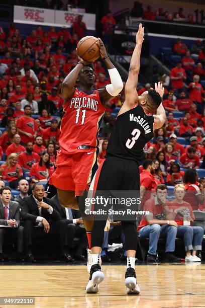 Jrue Holiday of the New Orleans Pelicans is fouled by CJ McCollum of the Portland Trail Blazers during the second half of Game Four of the first...