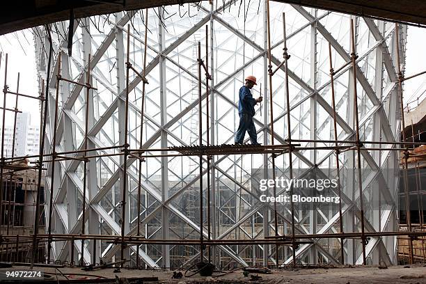 Construction worker labors inside a "boulevard horn" at the site of the 2010 World Expo in Shanghai, China, on Wednesday, Aug. 26, 2009. The expo...