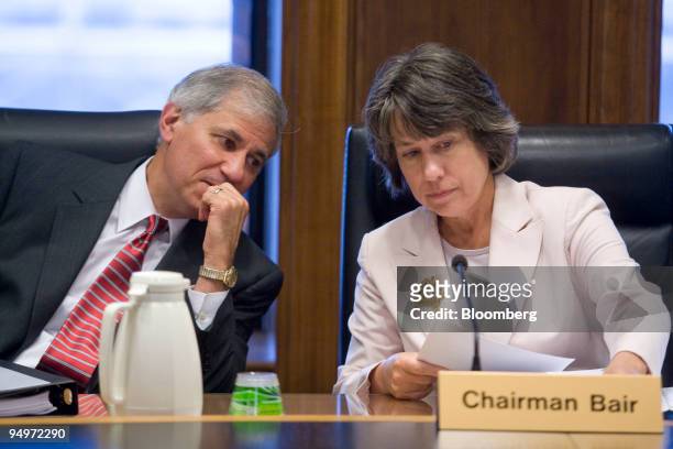 Sheila Bair, chairman of the Federal Deposit Insurance Corp., right, speaks to Martin Gruenberg, vice chairman of the FDIC, at an FDIC board meeting...