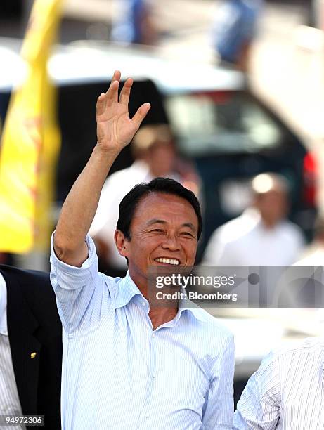 Taro Aso, Japan's prime minister and president of the Liberal Democratic Party , waves during a campaign rally for the Aug. 30 lower-house election,...