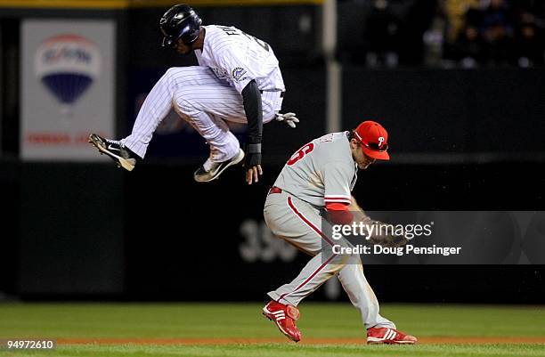 Dexter Fowler of the Colorado Rockies hurdles safely over Chase Utley the Philadelphia Phillies in Game Four of the NLDS during the 2009 MLB Playoffs...