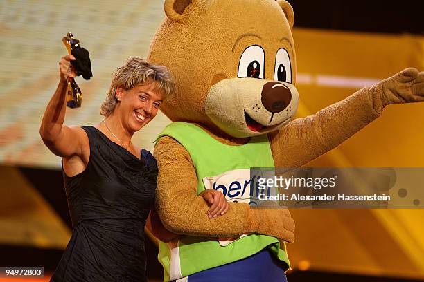 Steffi Nerius receives the female 'Athlete of the Year' award from Berlino, mascott of the World Track and Field Championships in Berlin 2009, during...