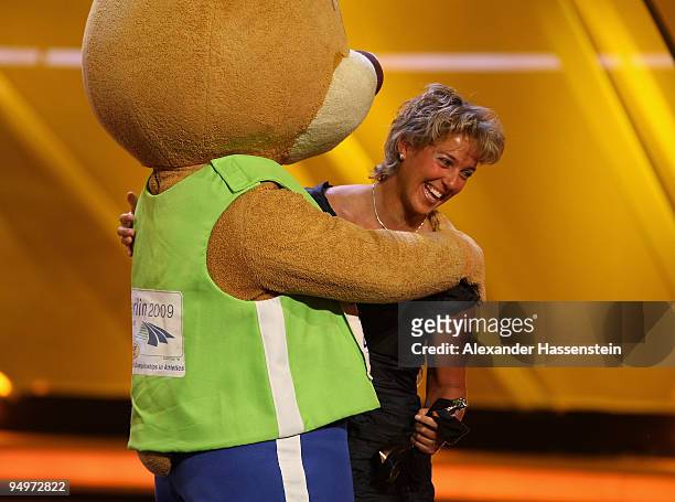 Steffi Nerius receives the female 'Athlete of the Year' award from Berlino, mascott of the World Track and Field Championships in Berlin 2009, during...