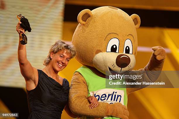 Steffi Nerius receives the female 'Athlete of the Year' award from Berlino, mascott of the World Track and Field Championships in Berlin 2009, during...