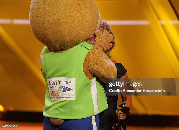 Steffi Nerius receives the female 'Athlete of the Year' award from Berlino, mascott of the World Track and Field Championships in Berlin 2009, during...